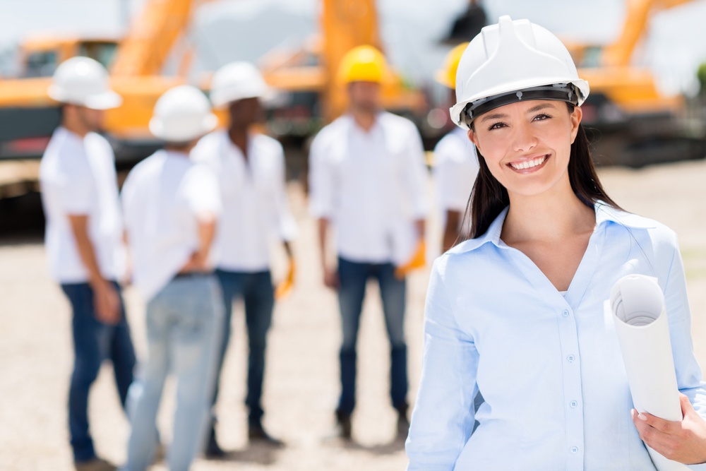 Female architect at a construction site looking happy.jpeg